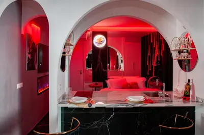 a living room with red walls and a red couch at Suite Tacco 12 in Rome