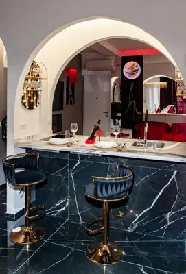 a kitchen with a bar with blue marble counter tops at Suite Tacco 12 in Rome