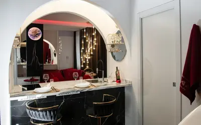 a dining room with a bar with a mirror at Suite Tacco 12 in Rome