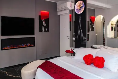 a bedroom with a bed with red flowers on it at Suite Tacco 12 in Rome