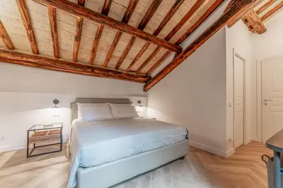 a bedroom with a bed and a wooden ceiling at Madama Lucrezia - Fontana di Trevi & Pantheon in Rome