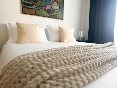 a white bed with a comforter on top of it at Il Sogno di Balduina a 1 min Stazione Appiano-Ospedale Gemelli in Rome