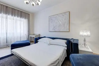 a white bedroom with a bed and a window at Il Sogno di Balduina a 1 min Stazione Appiano-Ospedale Gemelli in Rome