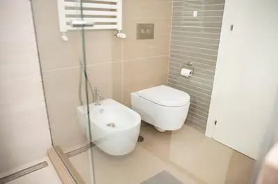 a bathroom with a toilet and a sink at Tempietto del Carmelo in Rome