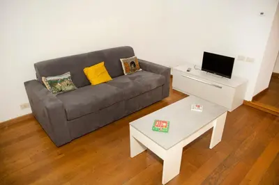 a living room with a couch and a table at Tempietto del Carmelo in Rome