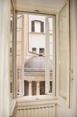 an open window with a view of a building at Tempietto del Carmelo in Rome