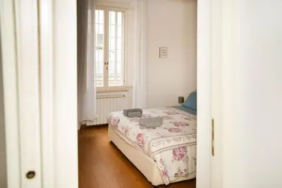 a bedroom with a bed in a room with a window at Tempietto del Carmelo in Rome