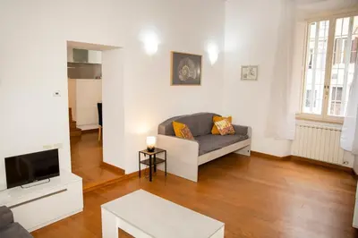 a living room with a couch and a tv at Tempietto del Carmelo in Rome