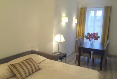 a bedroom with a bed and a table with a vase of flowers at Centro Roma Giallo - LOCAPPART in Rome