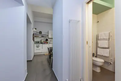a white bathroom with a toilet and a sink at Aurora Vatican House - San Pietro in Rome