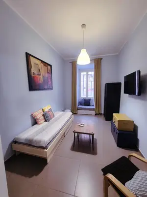 a living room with a bed and a table at Aurora Vatican House - San Pietro in Rome