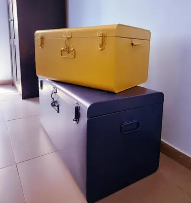 a yellow suitcase is sitting on top of a chest at Aurora Vatican House - San Pietro in Rome