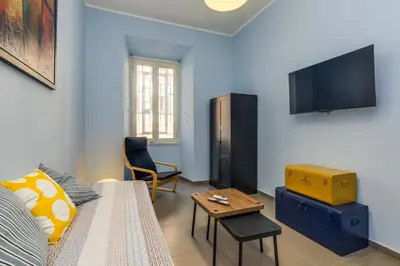 a living room with a couch and a tv at Aurora Vatican House - San Pietro in Rome