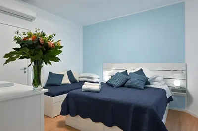 a bedroom with two beds with a vase of flowers at Jubilee 4 Your home in Rome Vatican in Rome