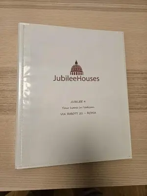 a book with the logo of a building on it at Jubilee 4 Your home in Rome Vatican in Rome