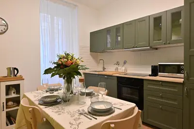 a kitchen with a table with a vase of flowers on it at Jubilee 4 Your home in Rome Vatican in Rome