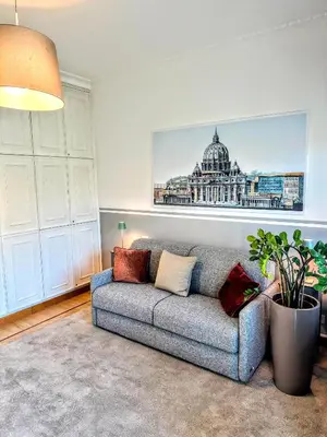 a living room with a couch and a picture of a building at Civico3 in Città Piazza del Popolo in Rome