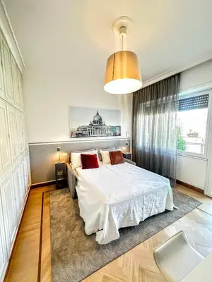 a bedroom with a white bed and a large window at Civico3 in Città Piazza del Popolo in Rome