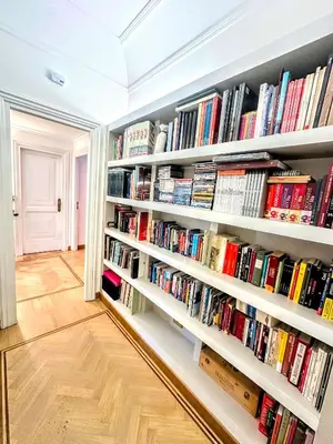 a library with white shelves filled with books at Civico3 in Città Piazza del Popolo in Rome