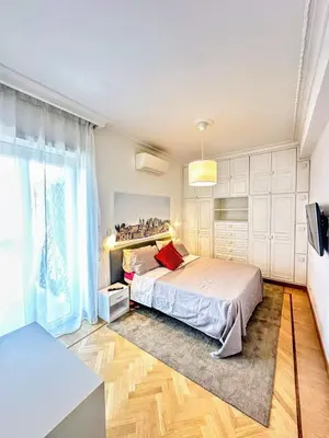 a bedroom with a bed and a large window at Civico3 in Città Piazza del Popolo in Rome