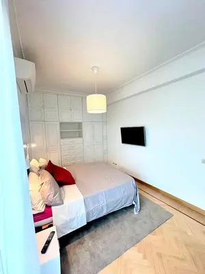 a bedroom with a bed and a flat screen tv at Civico3 in Città Piazza del Popolo in Rome