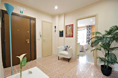 a living room with a chair and a plant at B&B Clelia in Rome