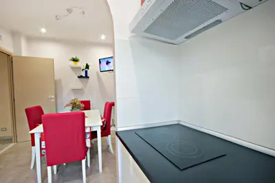 a room with a ping pong table and red chairs at B&B Clelia in Rome