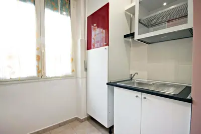 a kitchen with a sink and a refrigerator at B&B Clelia in Rome