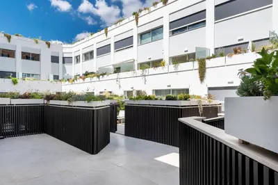 an exterior view of a white building with plants at Colosseum Luxury suite 26 in Rome