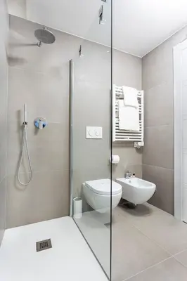 a bathroom with a shower and a toilet and a sink at Colosseum Luxury suite 26 in Rome