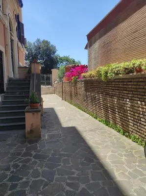 a sidewalk with a brick wall and a staircase at Foro appartament in Rome