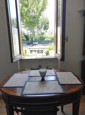 a table with a bowl on it in front of a window at Foro appartament in Rome