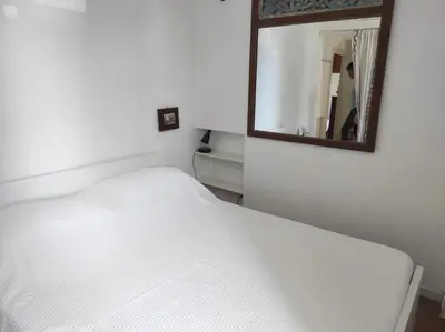 a bedroom with a white bed and a mirror at Foro appartament in Rome