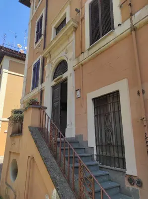 a building with a staircase leading to a door at Foro appartament in Rome