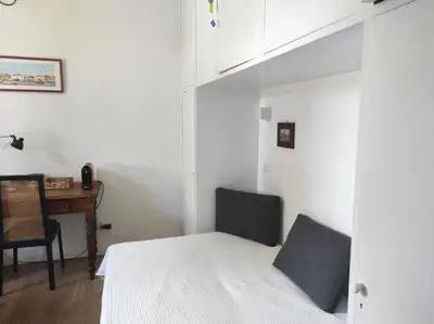 a small bedroom with a bed and a desk at Foro appartament in Rome