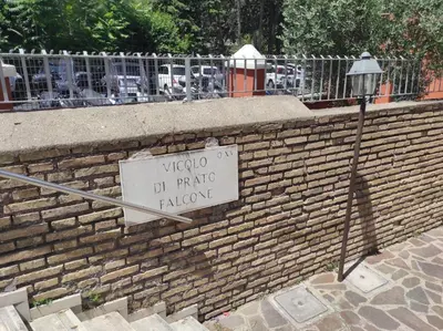 a sign on a brick wall next to a street light at Foro appartament in Rome