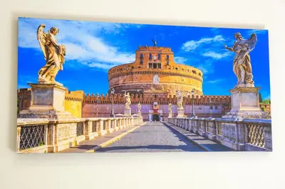 a building with statues on a bridge in front of it at Elegantis Gracchi Apartment - Your Chic Retreat in Central Rome - Vatican Area in Rome