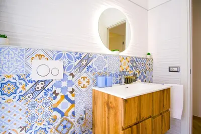 a bathroom with a sink and a tile wall at Elegantis Gracchi Apartment - Your Chic Retreat in Central Rome - Vatican Area in Rome
