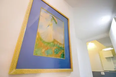 a picture of a painting hanging on a wall at Elegantis Veniero Suite Apartment - 1 Minute Walk to Vatican Museums in Rome