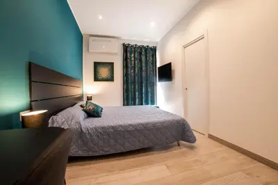 a bedroom with a large bed and a window at Michelangelo Luxury Rooms - Colosseo - WiFi in Rome