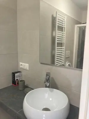 a bathroom with a white sink and a mirror at Michelangelo Luxury Rooms - Colosseo - WiFi in Rome