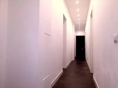 an empty hallway with white walls and a black door at I LOVE ROMA Guest House in Rome