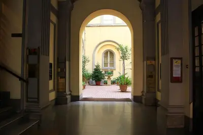 an arch way in a building with potted plants at I LOVE ROMA Guest House in Rome
