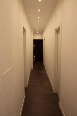 a hallway with white walls and a long corridor at I LOVE ROMA Guest House in Rome