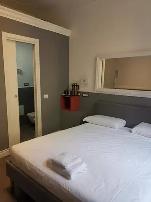 a bedroom with a bed with towels on it at I LOVE ROMA Guest House in Rome