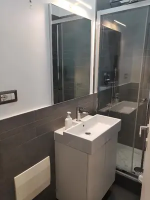 a bathroom with a white sink and a mirror at I LOVE ROMA Guest House in Rome