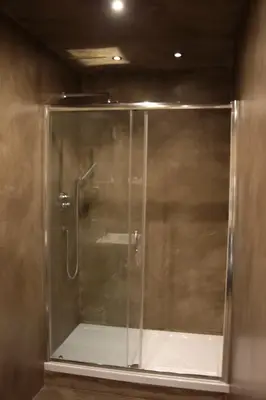 a shower with a glass door in a bathroom at I LOVE ROMA Guest House in Rome