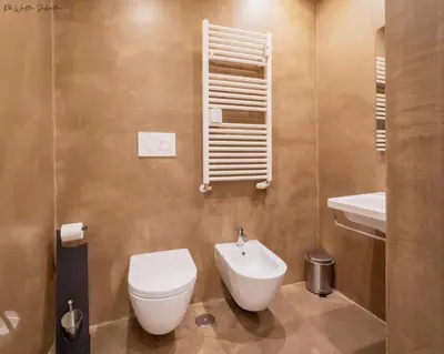 a bathroom with a toilet and a sink at I LOVE ROMA Guest House in Rome