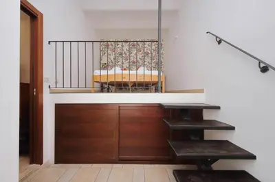 a staircase in a room with a bench and a table at Rifugio segreto nel cuore di Roma in Rome