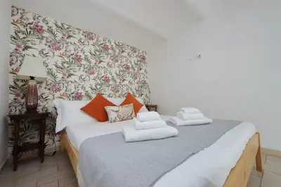 a bedroom with a bed with orange pillows on it at Rifugio segreto nel cuore di Roma in Rome